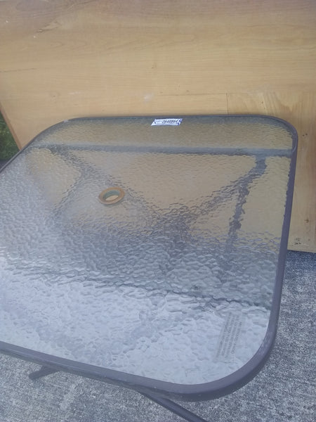 Mesa plegadiza con superficie de cristal con sombrilla